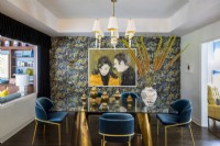Ornate dining room with floral patterned wallpaper and painting of Steve McQueen and Jacqueline Bisset.
