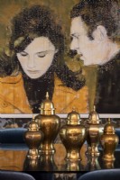 Display of bronze oriental jars and painting of Steve McQueen and Jacqueline Bisset.