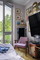 Pink armchair in an eclectic bedroom