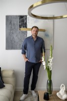 Interior designer standing on the background of the painting