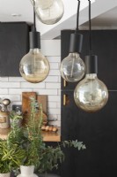 Pendant lights in industrial style kitchen diner