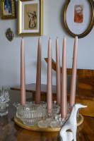 Pink candles standing on sideboards