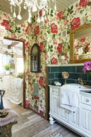 A bathroom with a wallpaper with roses