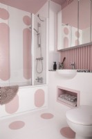 Contemporary bathroom with pink bauhaus painted shapes on the walls and floor.