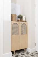 Hallway alcove with bespoke fitted birch ply cabinet with rattan panels
