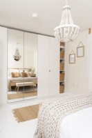 Fitted wardrobe and built in shelving in modern bedroom