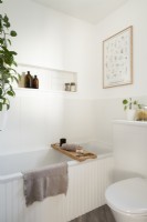White panelled bath with recessed wall shelf