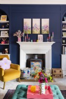 White fireplace and mantlepiece with blue panelled walls