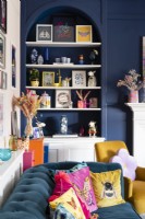 Blue panelled wall and alcove with shelving