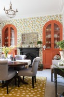 Colourful dining room with built in alcove arched cupboards