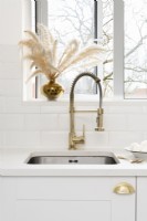 Kitchen sink and brass mixer tap