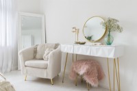 Corner of a white bedroom with chair and dressing table