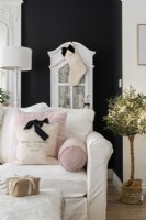 Detail of a white sofa and cushions in a black and white living room