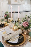 Detail of Christmas dining table place setting in open plan kitchen diner