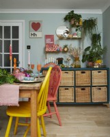 Dining room showing a painted storage unit and a festive table setting.
