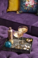 Close up of Christmas drinks tray on a purple ottoman.