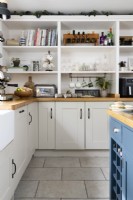 Cream and blue shaker style kitchen with open built in shelving