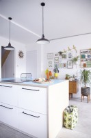 Open plan plywood kitchen with an island and blue worktops.