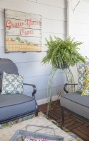 Detail of pallet painting and vintage plant stand in 3-season porch makeover