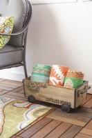 Crate of kantha throws on wood tile floor