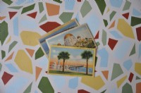 Vintage postcards on painted tabletop. Color inspiration for 3-season porch makeover.