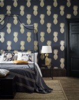 Modern bedroom with 4 poster bed and pineapple wallpaper