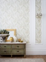 Wallpapered panelled wall with rustic consul table 