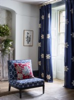 Blue curtains and blue patterned chair in living room