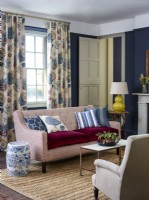 Sofa in classic living room with patterned curtains