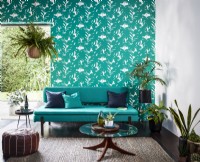 Green patterned wallpaper with matching green sofa