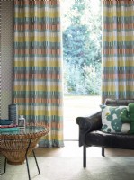 Patterned curtains with modern retro chair and coffee table