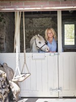 Home owner portrait with horse in Stables 
