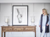 Home owner portrait against panelled wall with horse picture