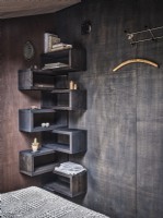 Black wooden corner shelf unit in modern bedroom 