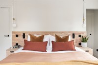 Contemporary bedroom with wooden headboard.