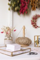 Detail of a corner in a craft room with dried flowers and wreath making tools