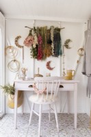 Dried flower craft room with an upcycled painted desk and chair 