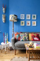Gray sofa with cushions in a colourful blue living room