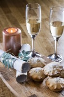 Detail of mince pies, champagne and Christmas crackers