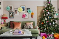 Colourfully decorated Christmas tree in feminine living room