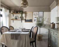 Country style dining room with table laid for dinner
