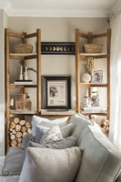 Wooden shelving unit in modern neutrally decorated living room