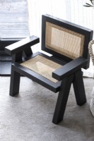 Detail of black wooden armchair with jute panels