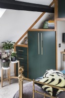 Green built-in wardrobe in modern bedroom