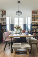 Bookcases and window seat in modern dining room 