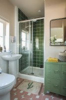 Modern bathroom with green tiling in shower cubicle