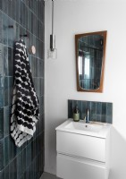 Contemporary white bathroom with grey tiling and vintage mirror