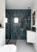 Contemporary white bathroom with tiled grey feature wall 