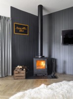 Lit wood burning stove in contemporary living room