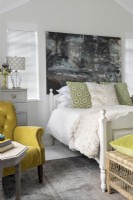 Bedroom with yellow velvet armchair